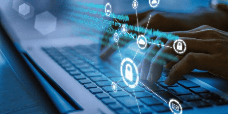 Hands typing on a laptop keyboard