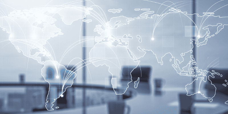 A map of the world superimposed over a conference table.